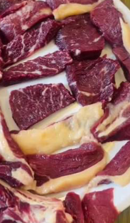 Multiple beef cuts on white paper showing variety